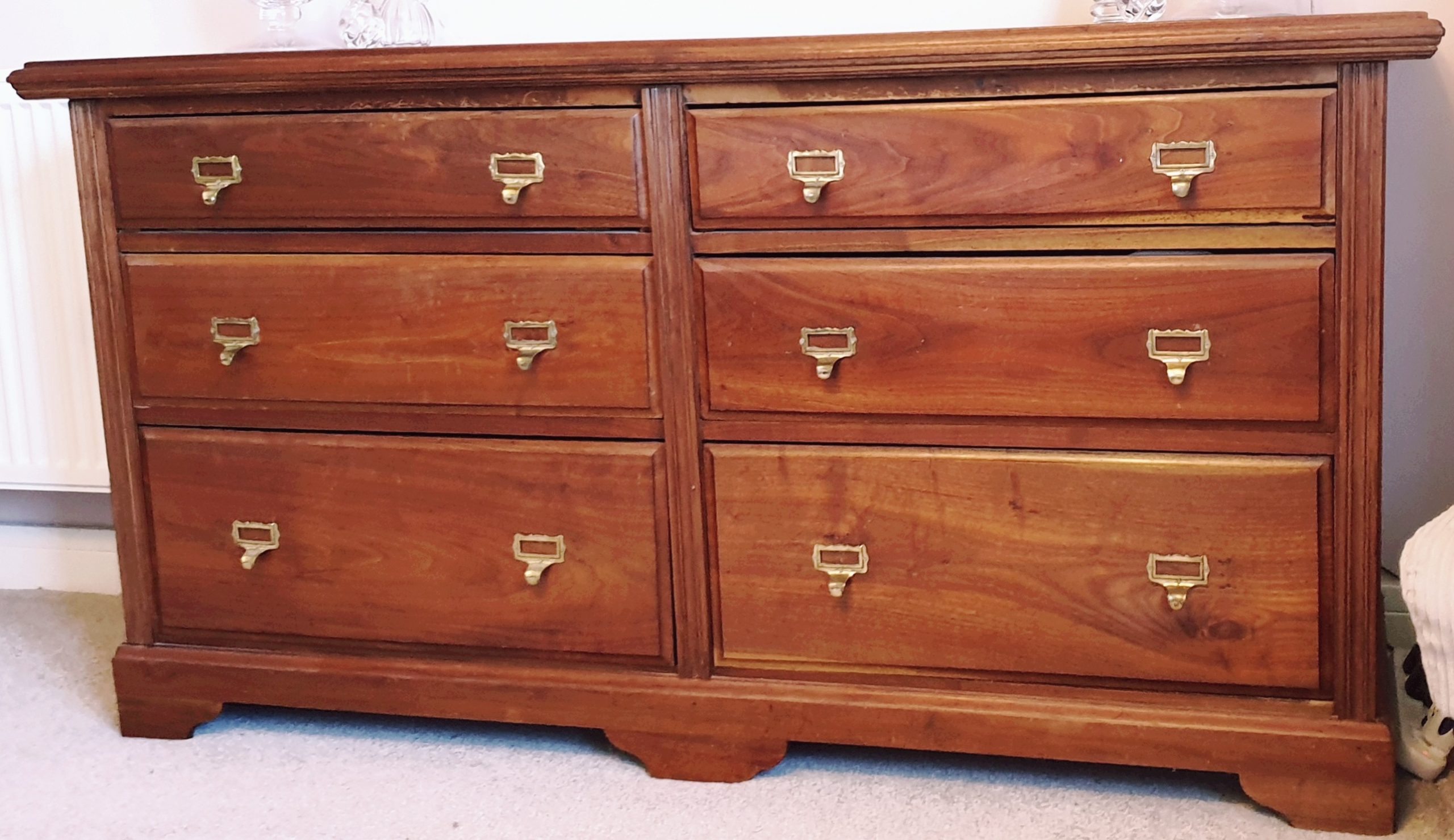 Chest of drawers created by heavily modifying an ornate antique mahogany dresser.